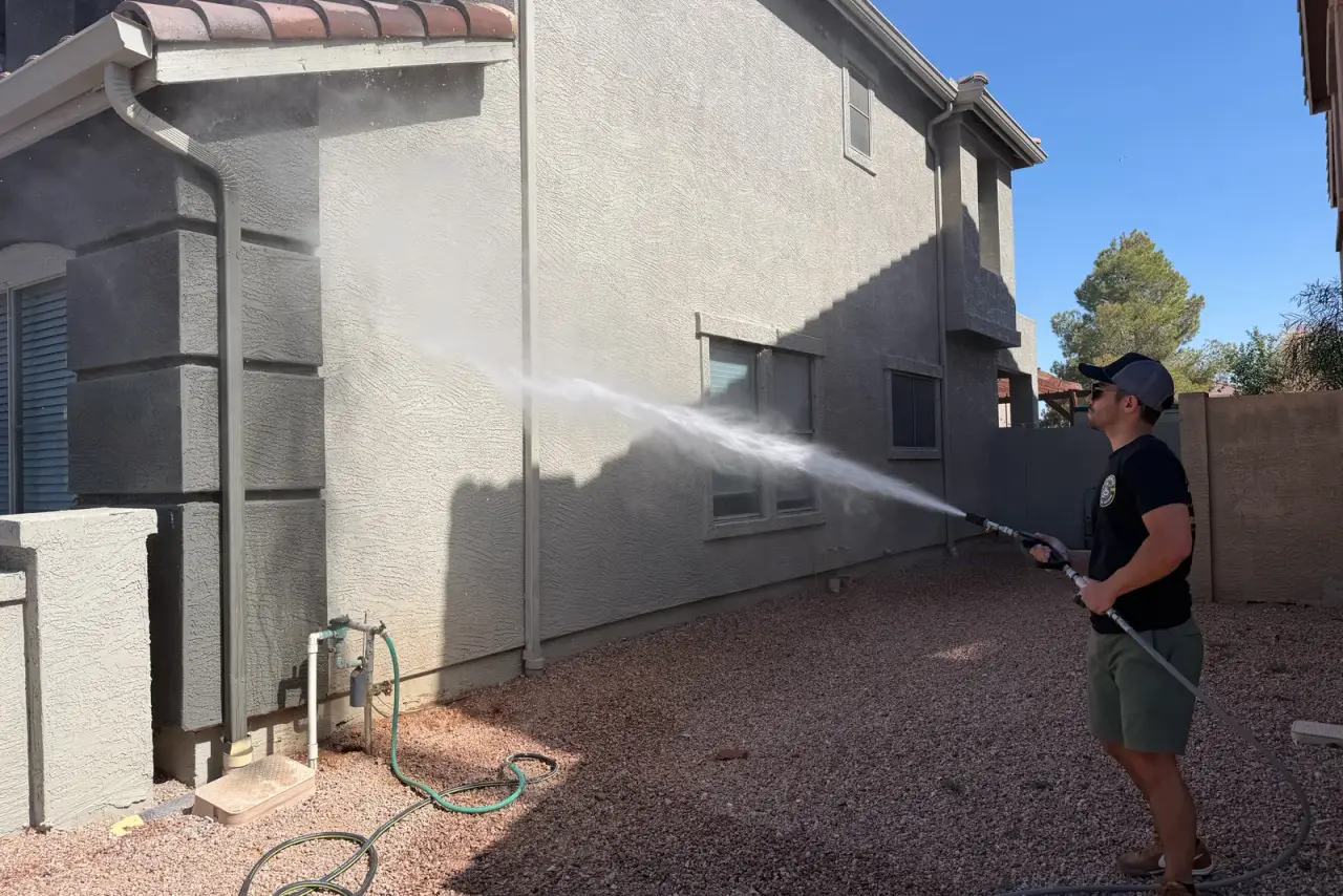 Soft washing the exterior wall of a stucco home in Arizona
