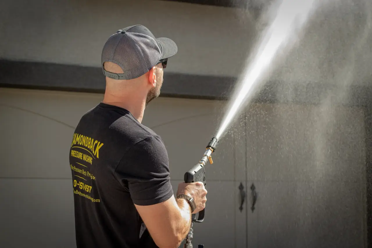 Diamondback tech soft washing a tile-roof home exterior in the East Valley