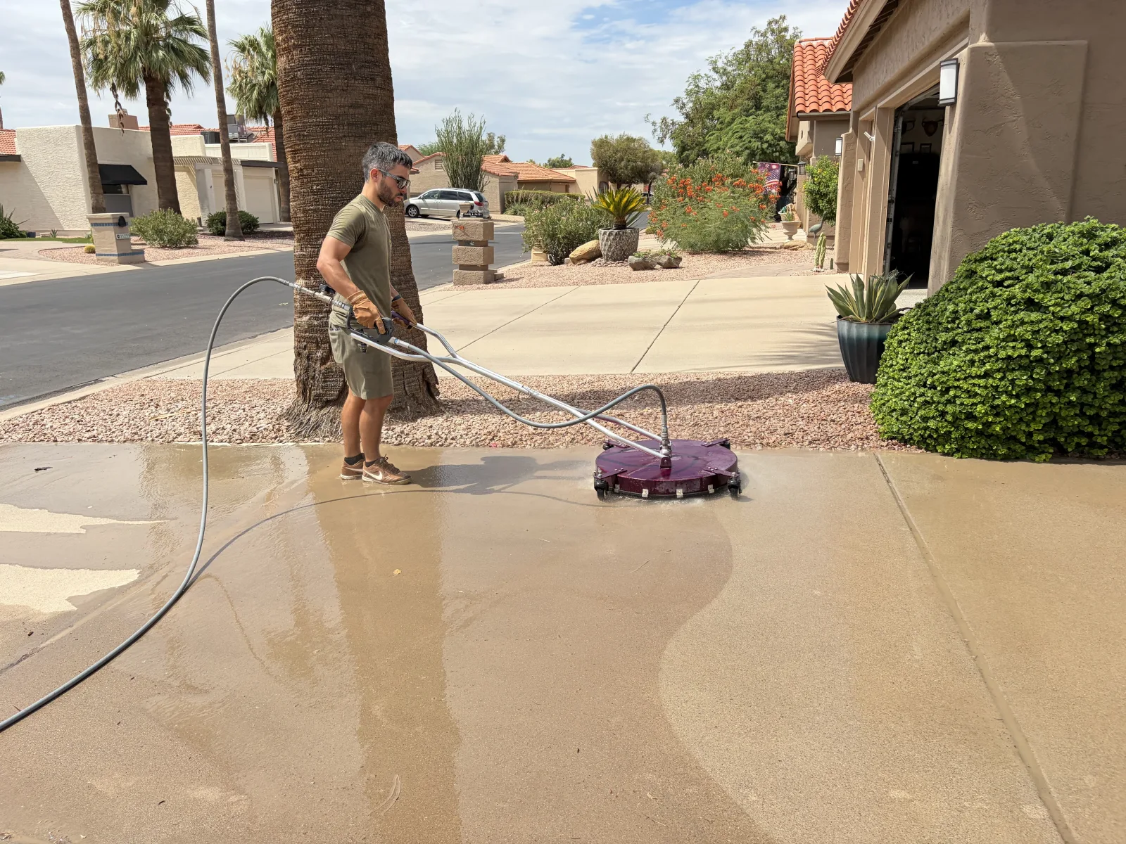 Clean concrete driveway after hot-water pressure washing