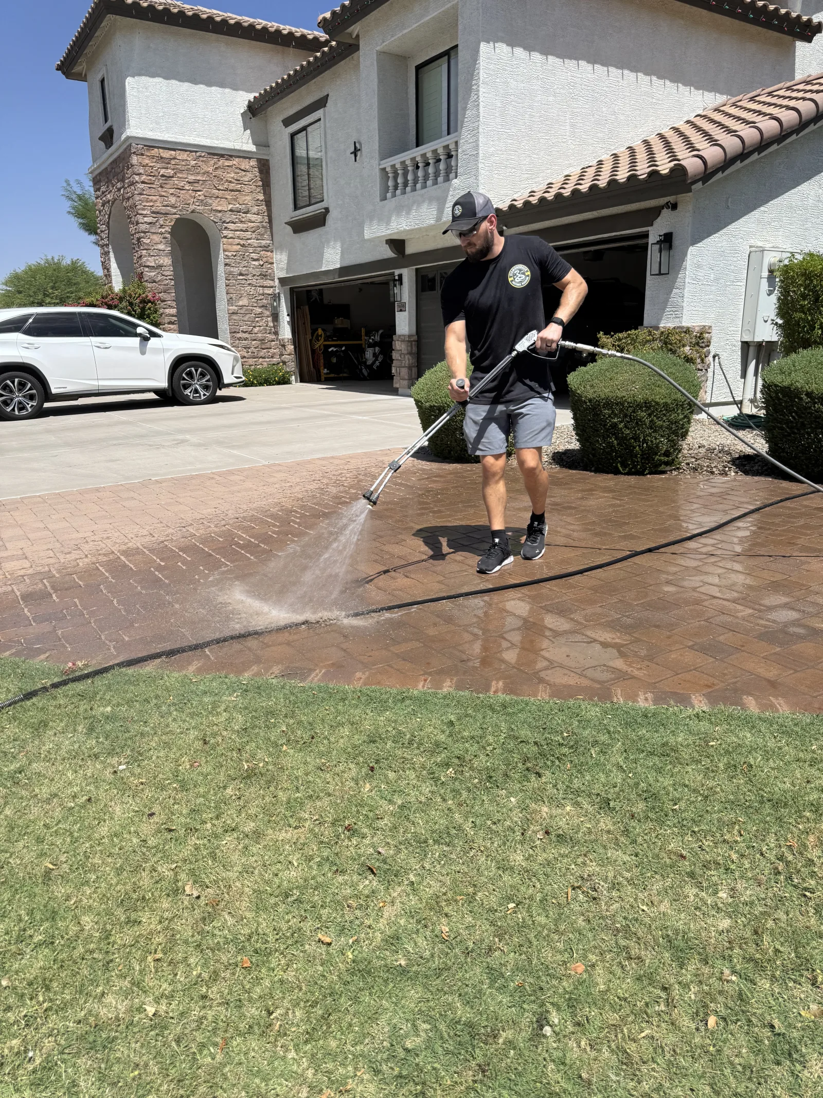 Diamondback technician washing a paver walkway at an Arizona home
