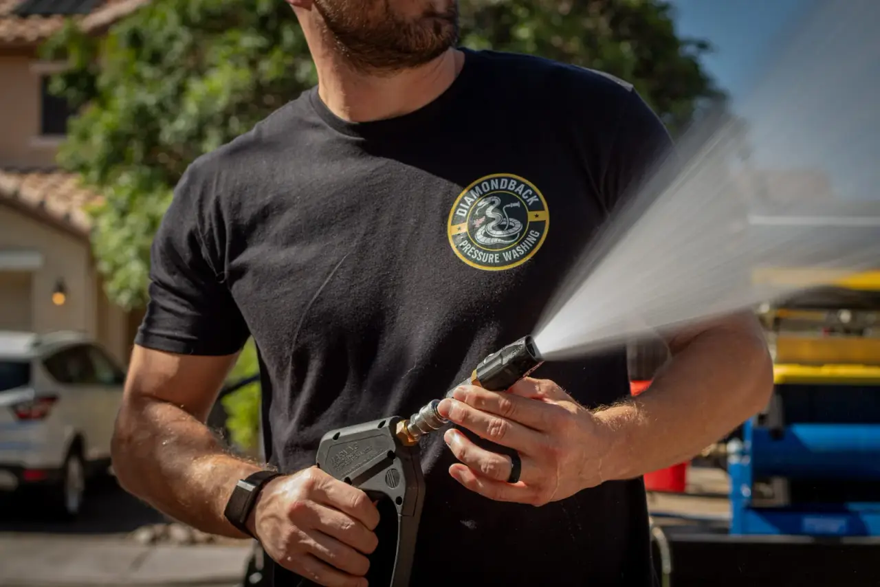 Diamondback technician pressure washing a Gilbert property